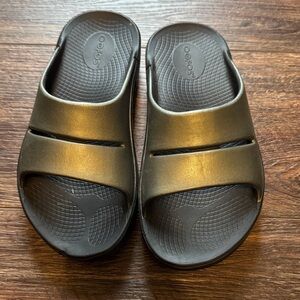 OOFOS Metallic Gold and Black Slides